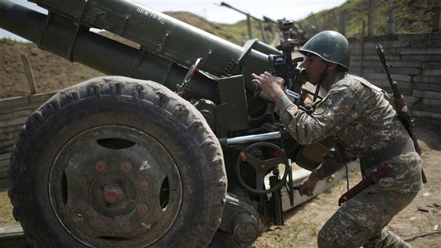 An ethnic Armenian soldier adjusts a cannon’s aim at artillery positions near the Nagorno-Karabakh’s town of Martuni, April 7, 2016. 