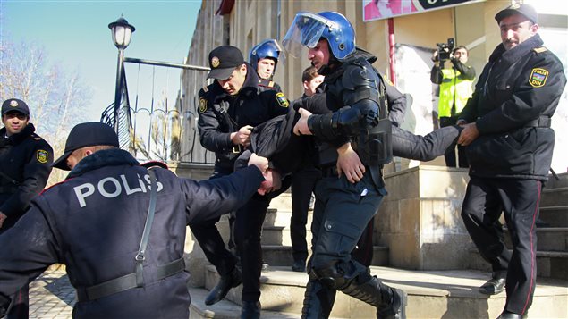 Police detain a protester in the town of Ismaili, 200 km (124 miles) northwest of the capital Baku, January 24, 2013. Azeri police used tear gas and water cannon to disperse hundreds of protesters demanding a local leader’s resignation on Thursday after cars and a hotel were torched in a night of rioting.